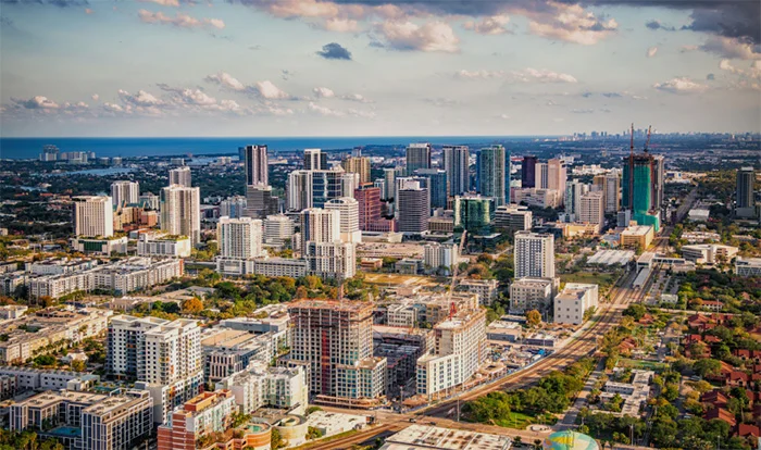 Aerial view of downtown Austin skyline with modern buildings and green spaces under cloudy sky