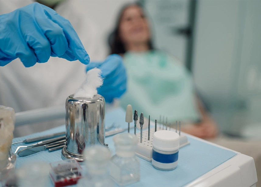 Healthcare professional handling medical samples with patient in background at clinical laboratory