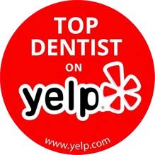 Top Dentist on Yelp red badge award with white text and Yelp logo