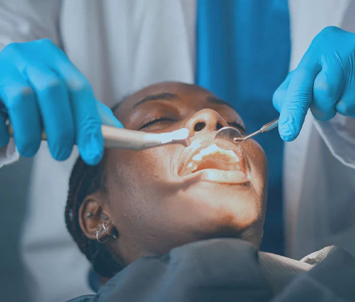 Dentist examining patient's teeth with dental tools during oral checkup procedure