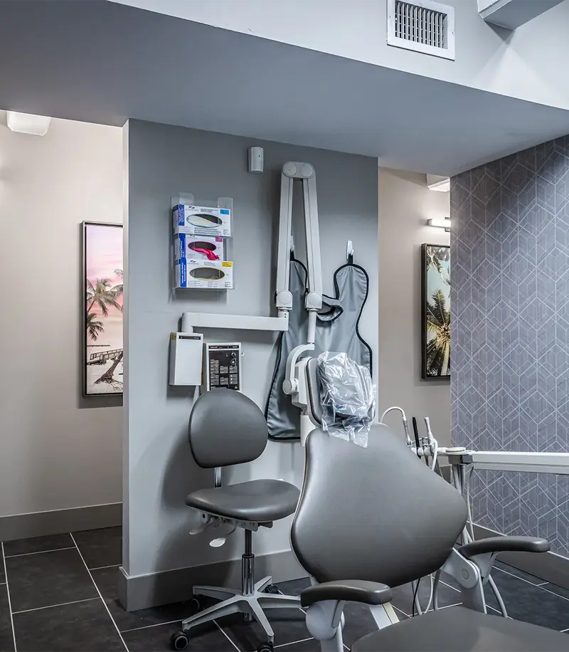 Modern medical office with gray ergonomic chairs, framed artwork, and contemporary decor in neutral tones